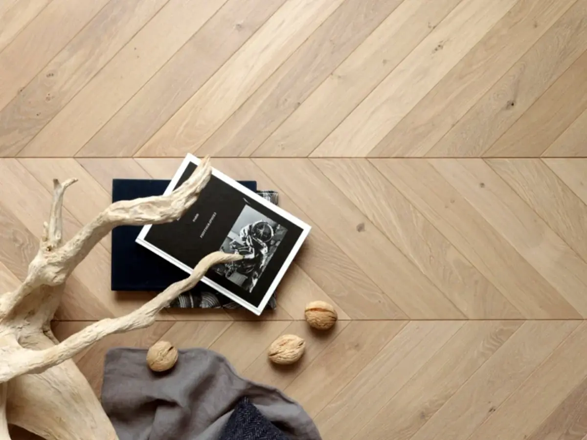 Chevron-pattern engineered oak flooring in a warm natural finish