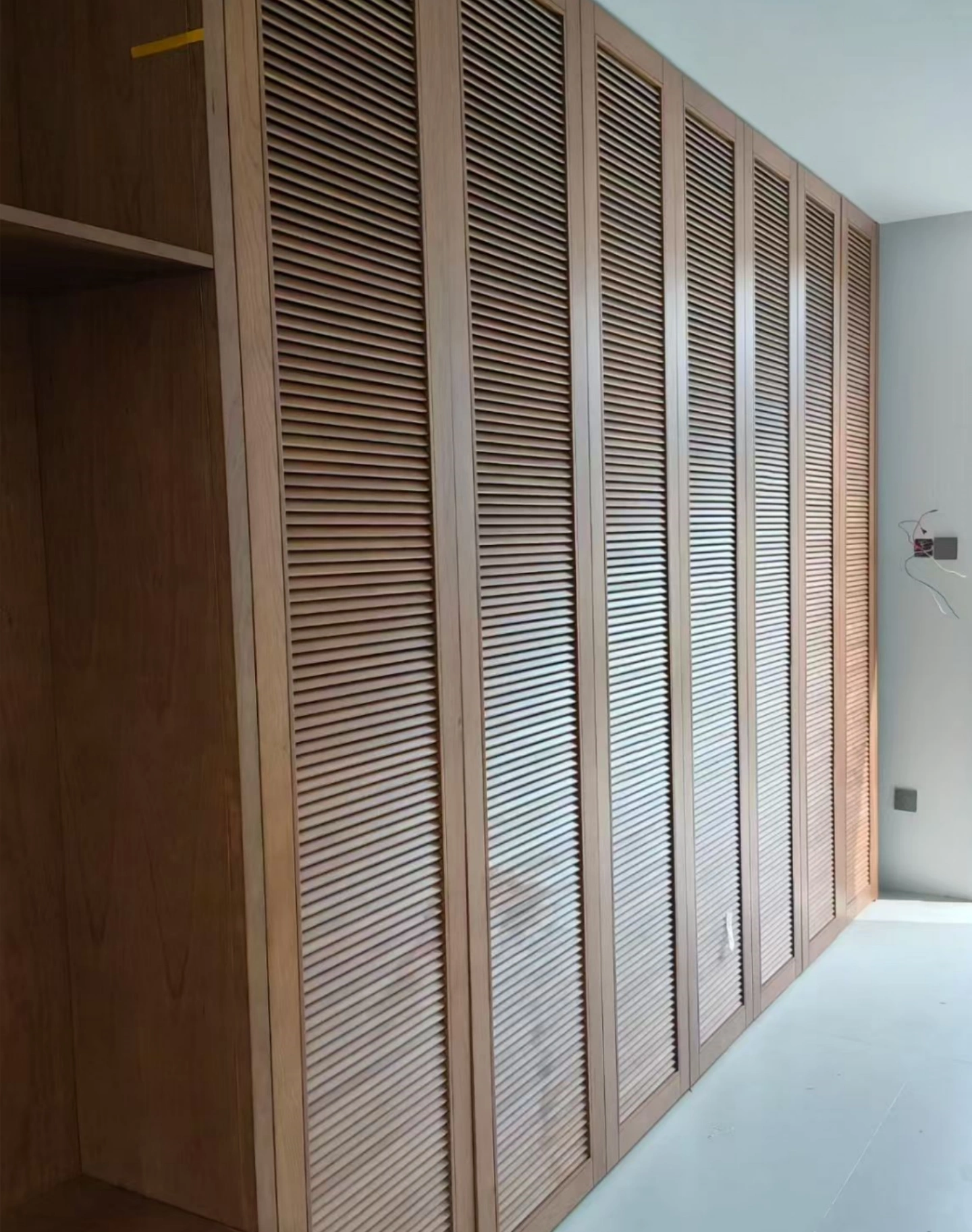 Floor-to-ceiling louver wardrobe with custom storage solutions in Sydney Australia
