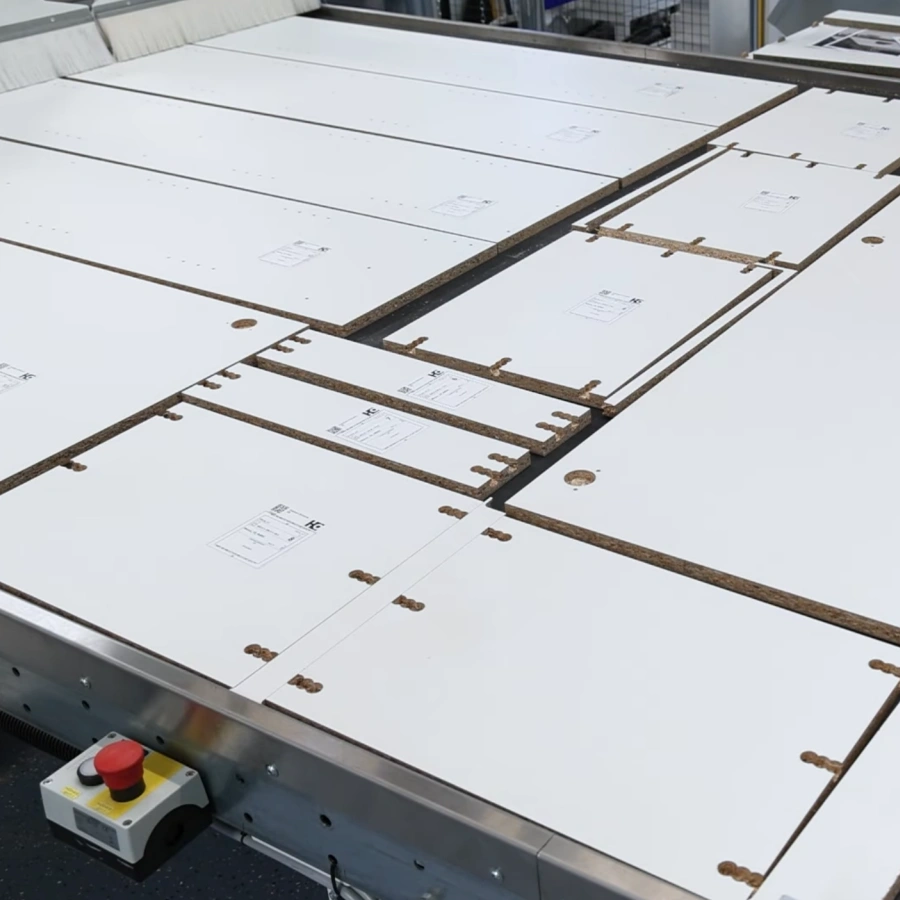 Accuracy cutting of wood panels using HOMAG CNC machinery in a professional cabinetry factory